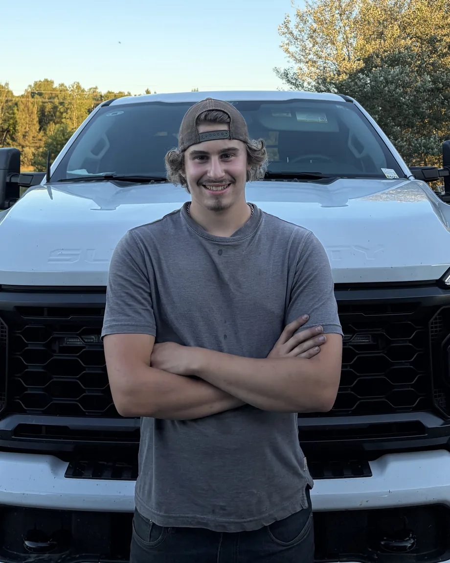 Kayden Edwards, owner of Edwards Landscape and Construction, in front of his work truck in North Bay