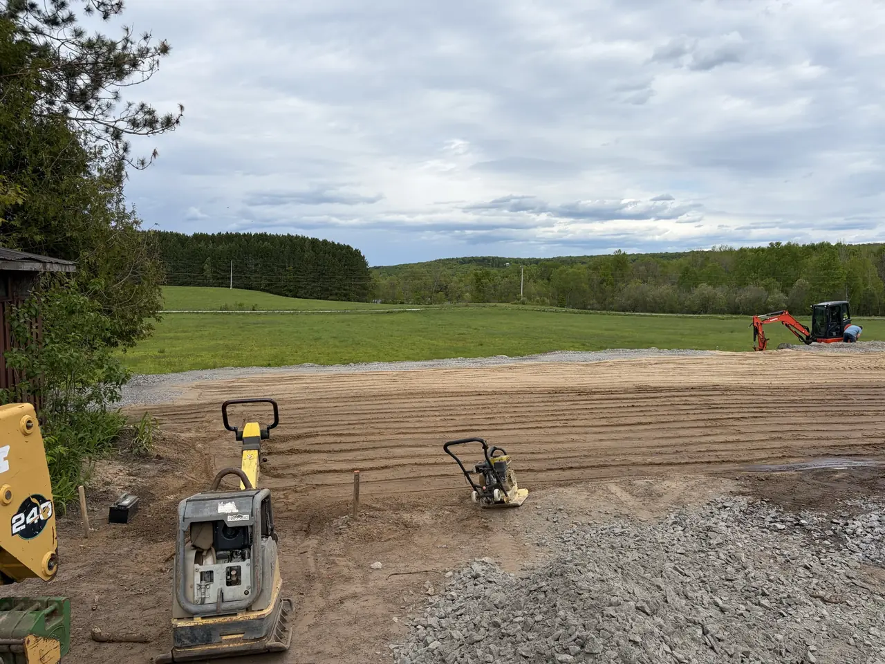 Yard grading and site preparation with a plate compactor by Edwards Landscape and Construction near North Bay