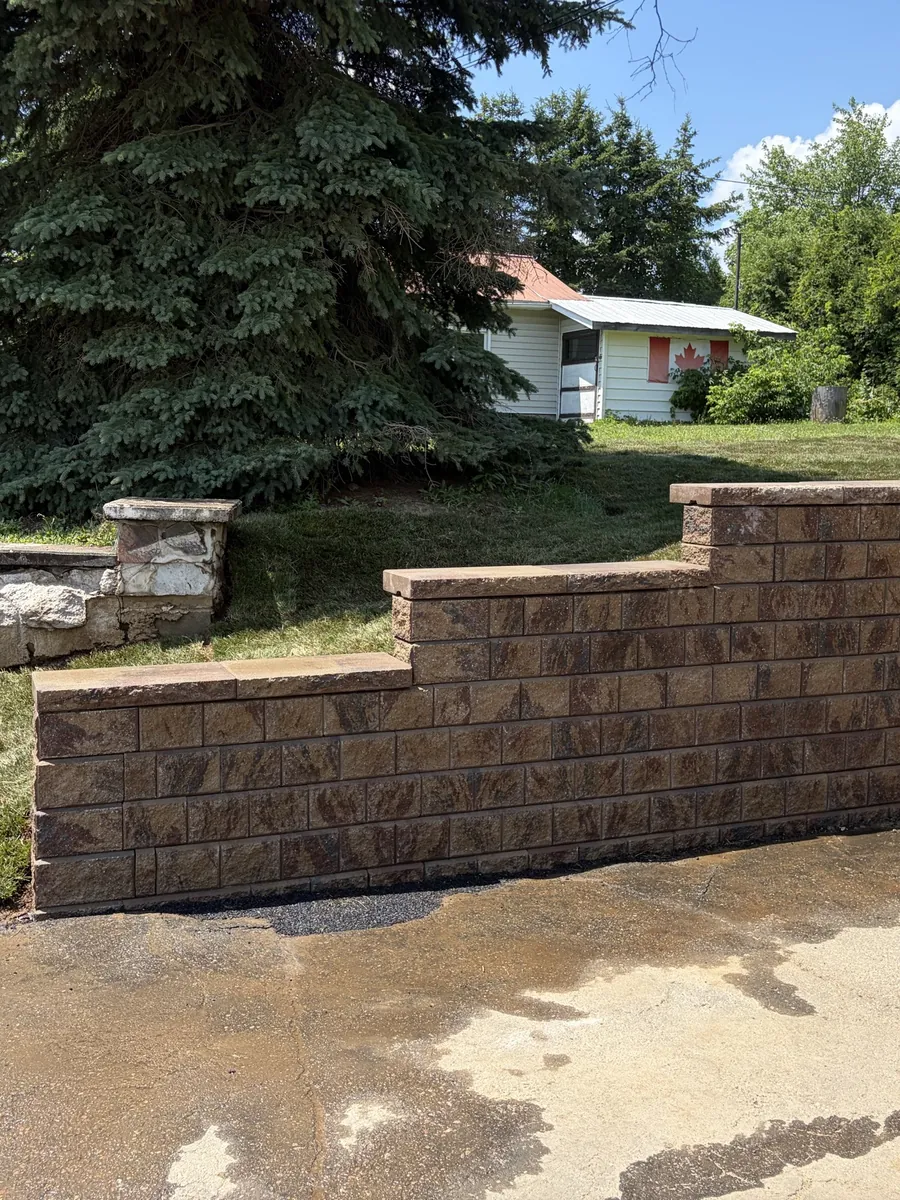 Engineered block retaining wall and steps built by Edwards Landscape and Construction near North Bay
